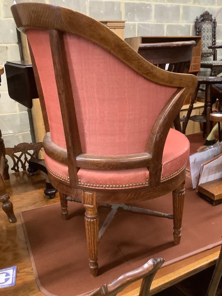 A Victorian oak revolving desk chair, by Waring & Sons Ltd of London, width 57cm